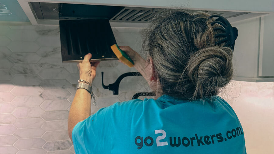 A Go2 Workers professional cleaning a range hood in a Central Florida home