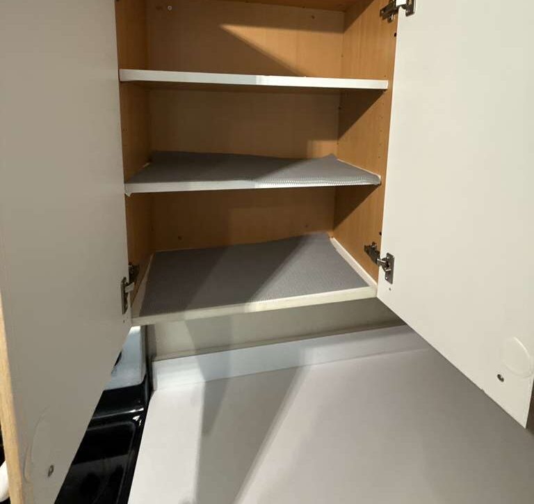 Cabinet interiors — Shelves wiped clean inside every door. Go2 Workers deep cleaning, Winter Park, FL