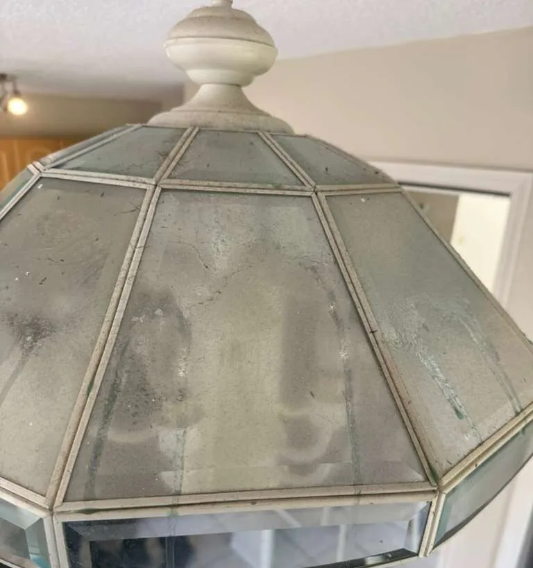 Before: chandelier & light fixtures in a Winter Park home before a Go2 Workers deep cleaning